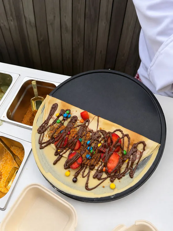 Fresh crepe cooking on the round live station griddle